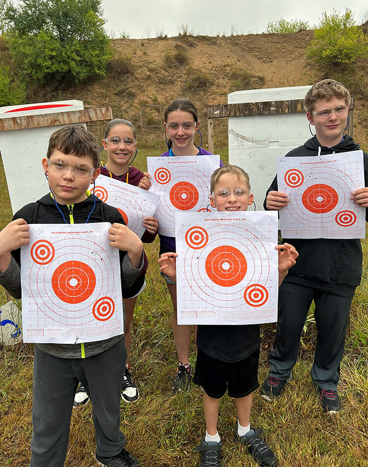 Five youth participants holding up targets.
