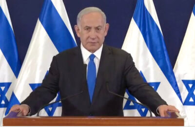 Benjamin Netanyahu at a podium.