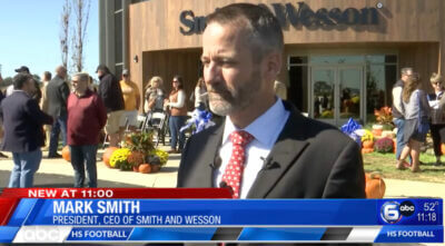 CEO of Smith and Wesson at ribbon-cutting ceremony.