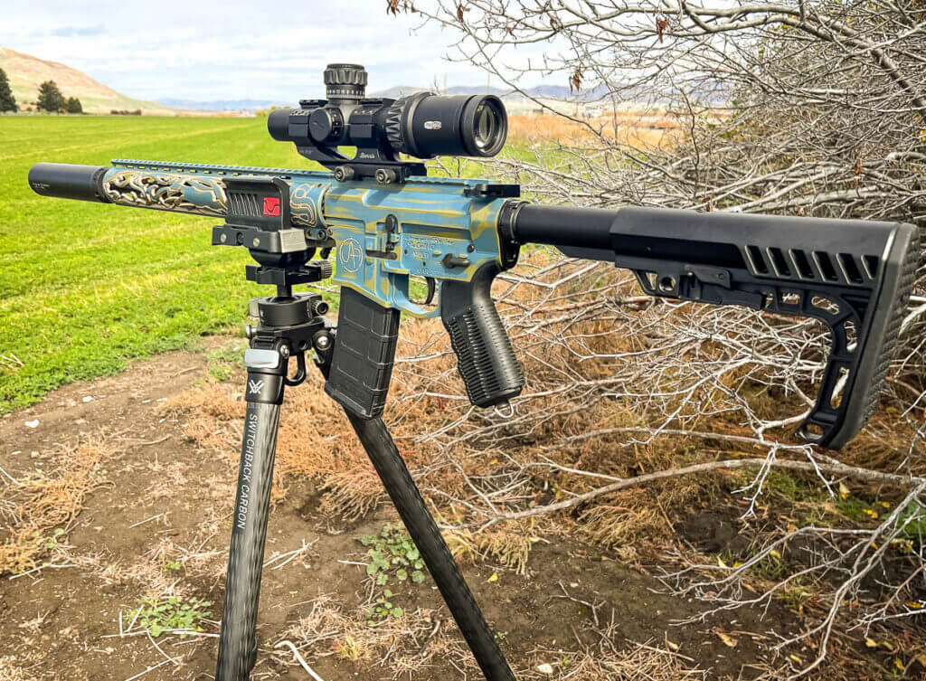 Gorgeous blue and gold long rifle on Vortex Switchback Carbon tripod outside 