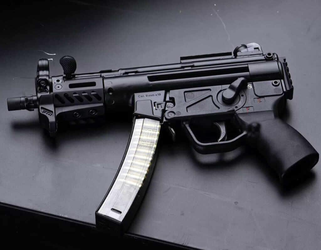 An MP5K sits on a black table.