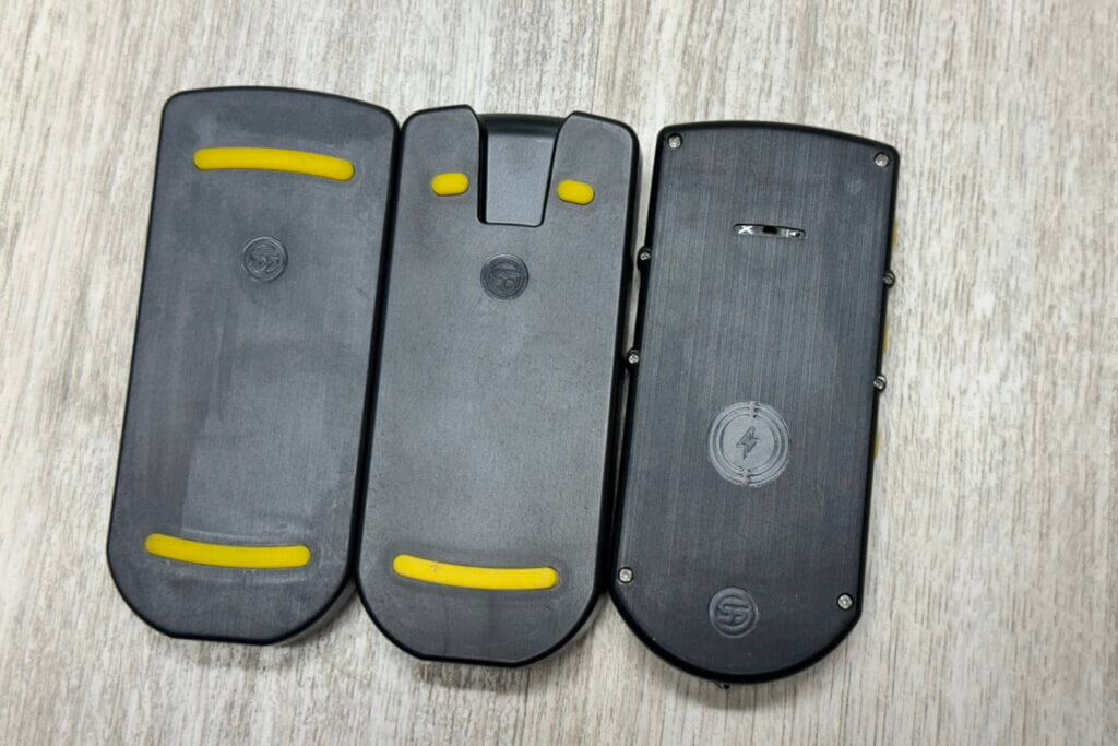 3 - Train With Purpose: Shooters Global Shot Timer Review U-Grip holders. Left is the original, the middle one is what currently ships with the timers, and on the right is the timer itself with the buzzer microphone slit in the top middle.