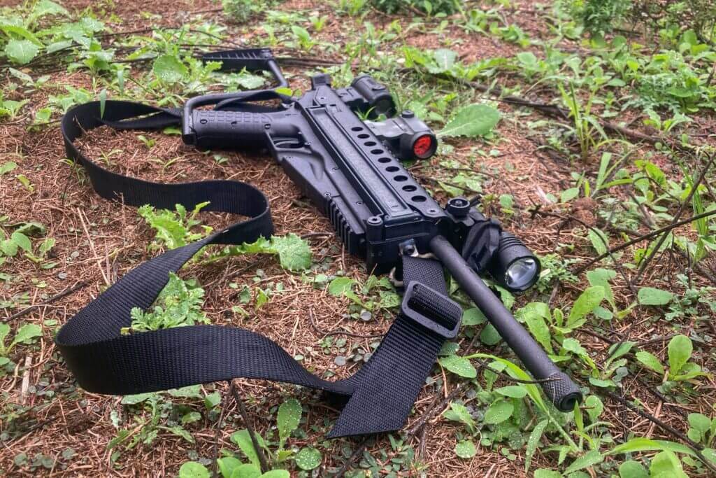 3 - KelTec R50: Poor Man's P90? KelTec R50 laying on damp grass. threaded muzzle.