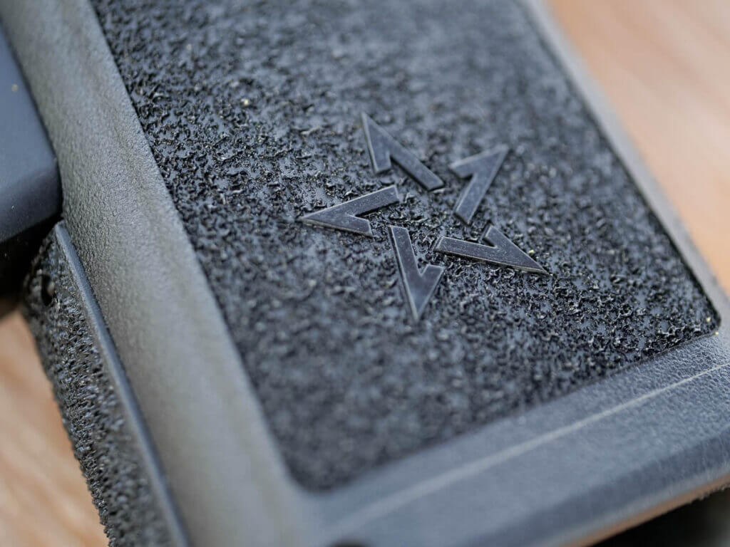 Close up view of the bottom of the textured grip showing the logo five-point star.