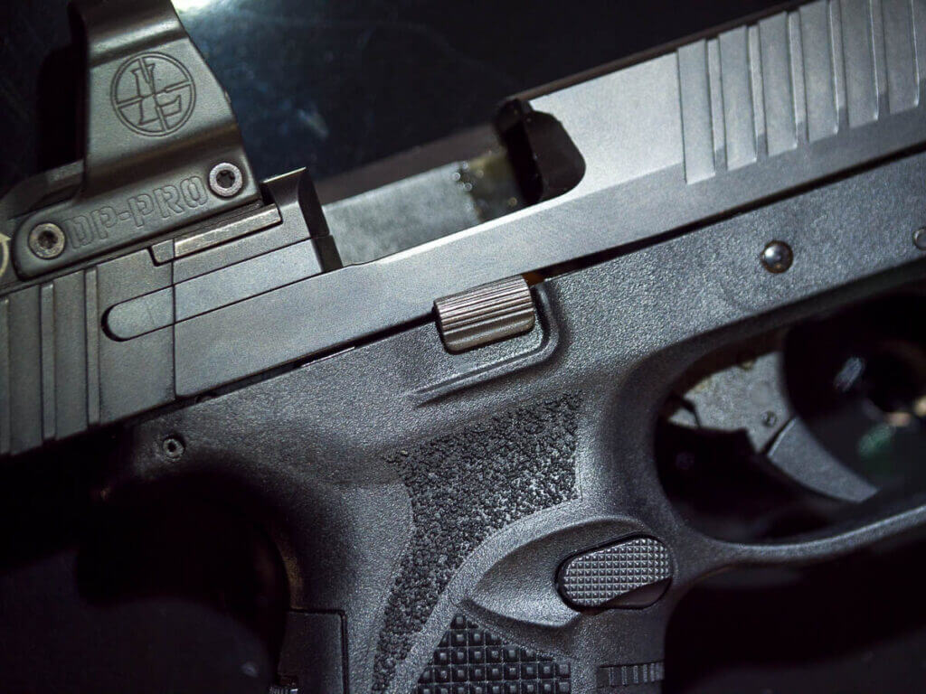 Close up view of the right side of the gun. The slide is open and the ejection port is revealed.