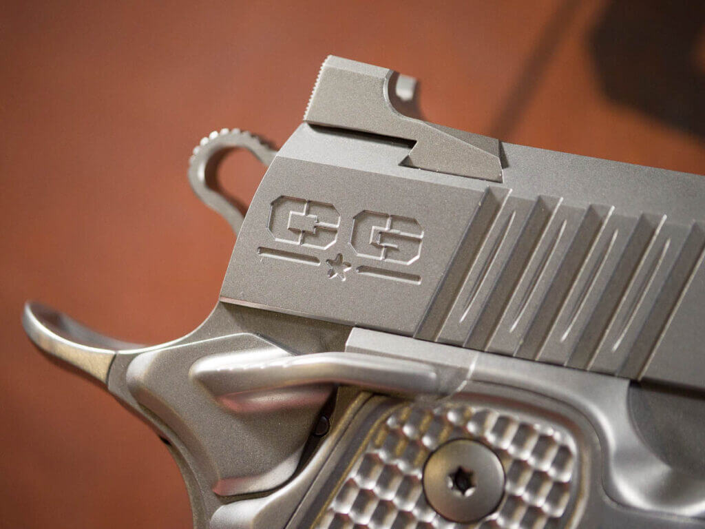 Close up view of the back  of the slide on the right side including the beavertail, safety lever, and skeletonized hammer. The engraved Cabot Guns logo are the only letters visible on the gun.