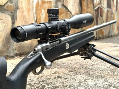 A long-range rifle scope is mounted to a rifle.