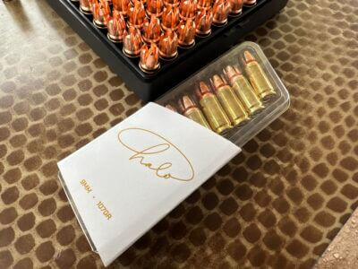 A box of bullets is desplayed on a table.
