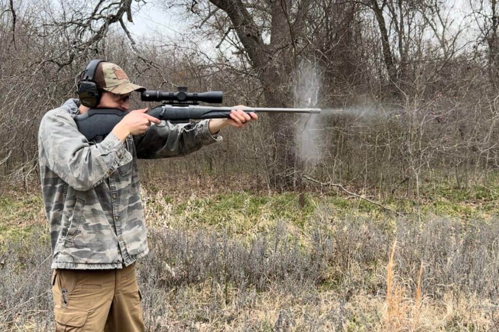 Shooter aiming down barrel of Ruger American Gen II Rifle