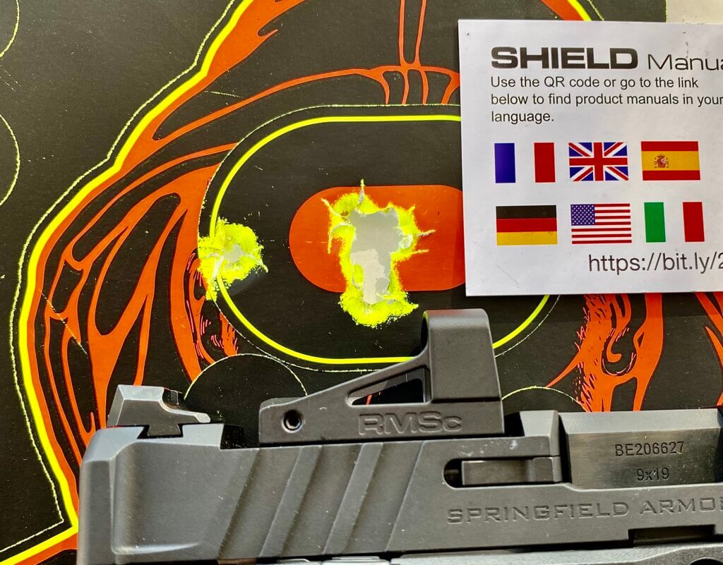 Shield RMSc Glass Edition red dot in front of neon target