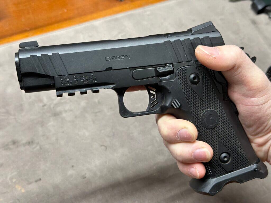 A black Witness2311 held in a man's hand.