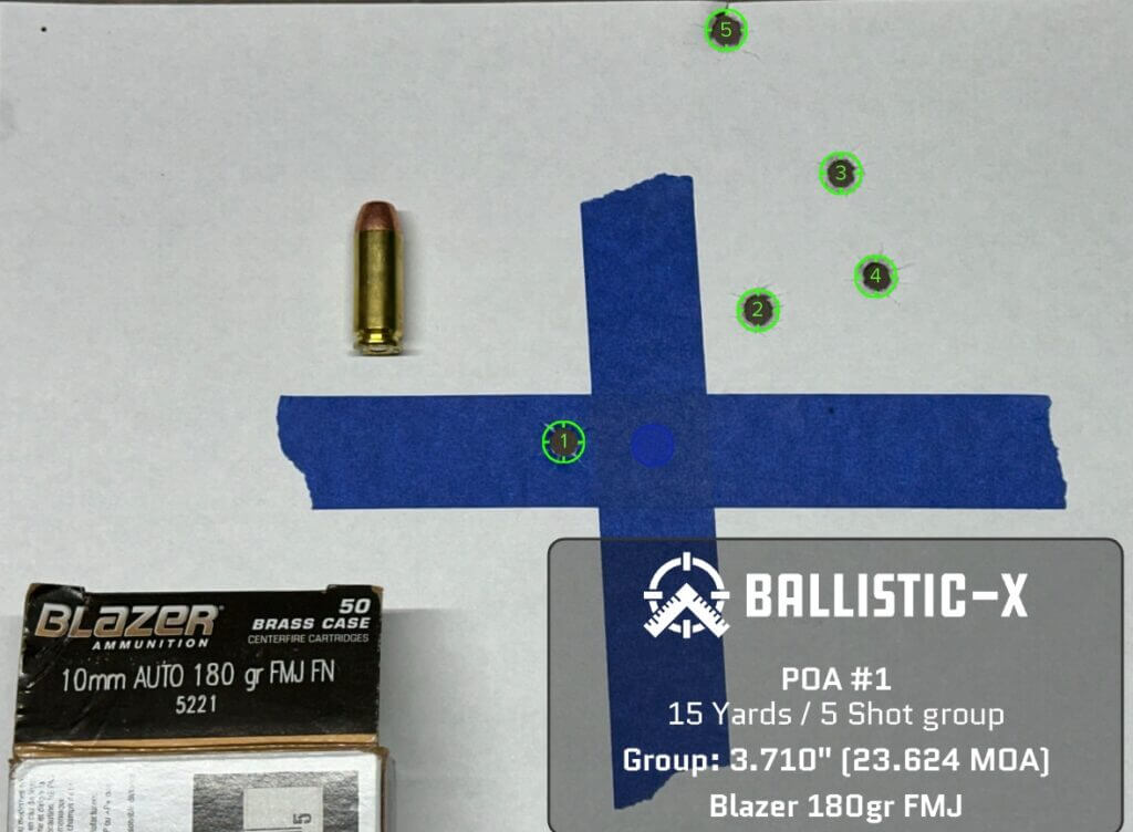 Five bullet holes are grouped on a target.