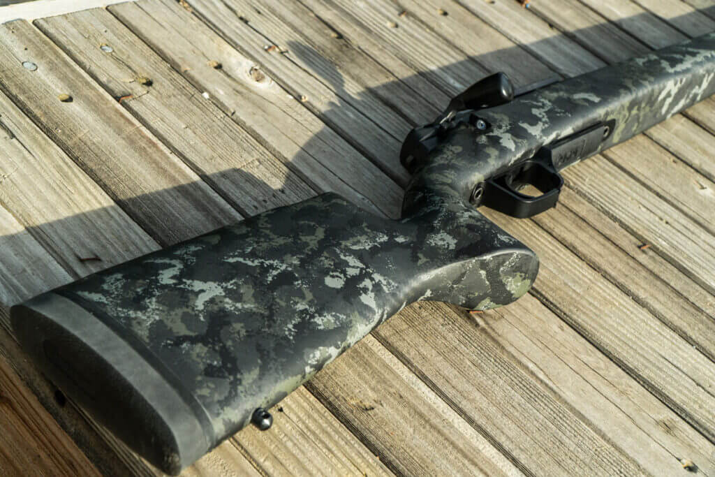 Strasser RS 700 Tungsten colored Carbon Fiber stock laying on it's side