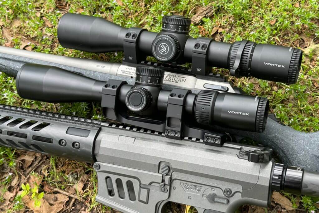 A rifle and a shotgun with Vortex scopes installed on them