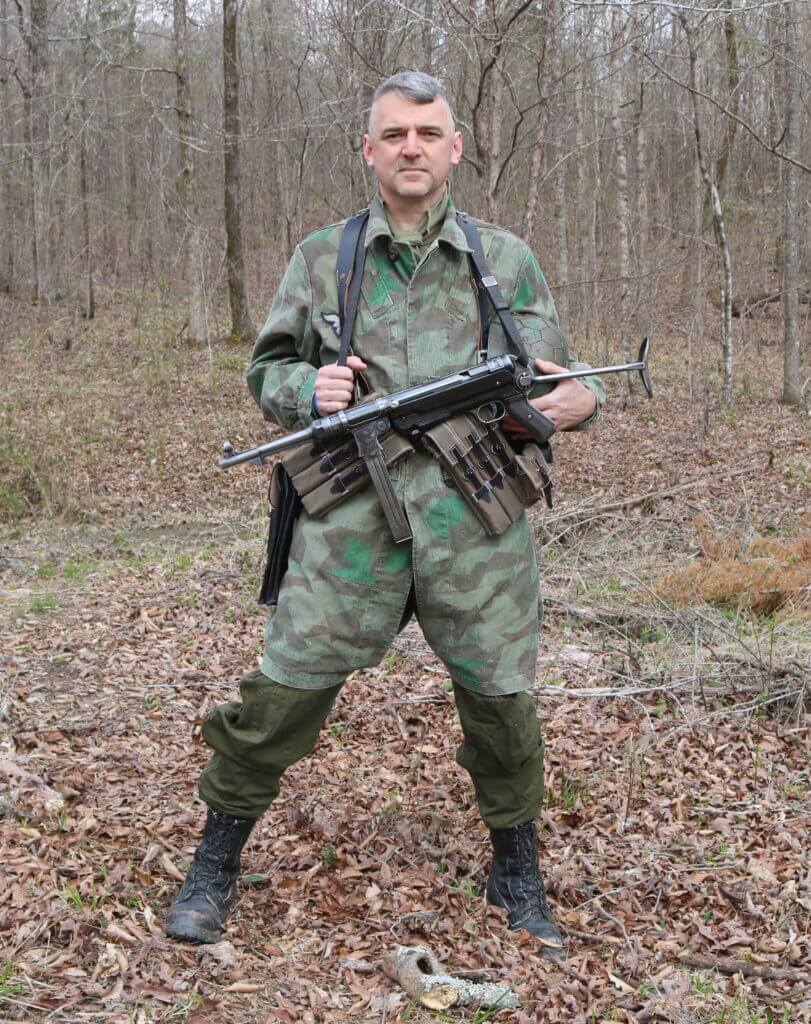 Man in camo holding vintage gun