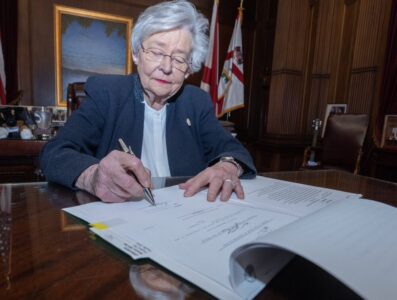 Alabama Governor Kay Ivey signs a bill into law.