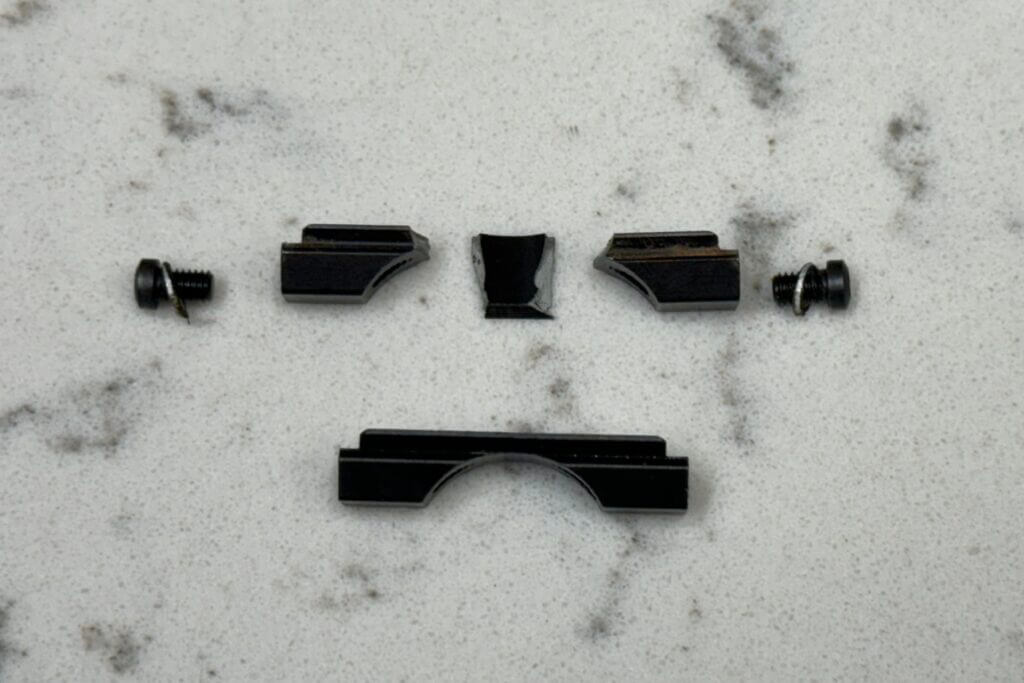 parts for gun sitting on marble counter