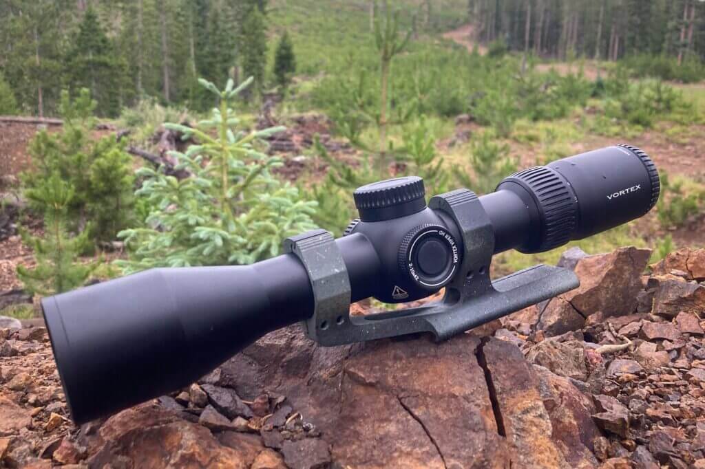 Vortex scope on jagged red rock in forest