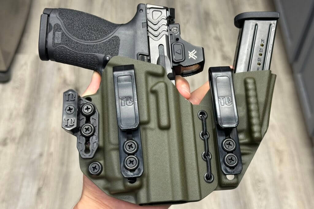 Smith & Wesson M2.0 Carry Comp holstered with extra magazine