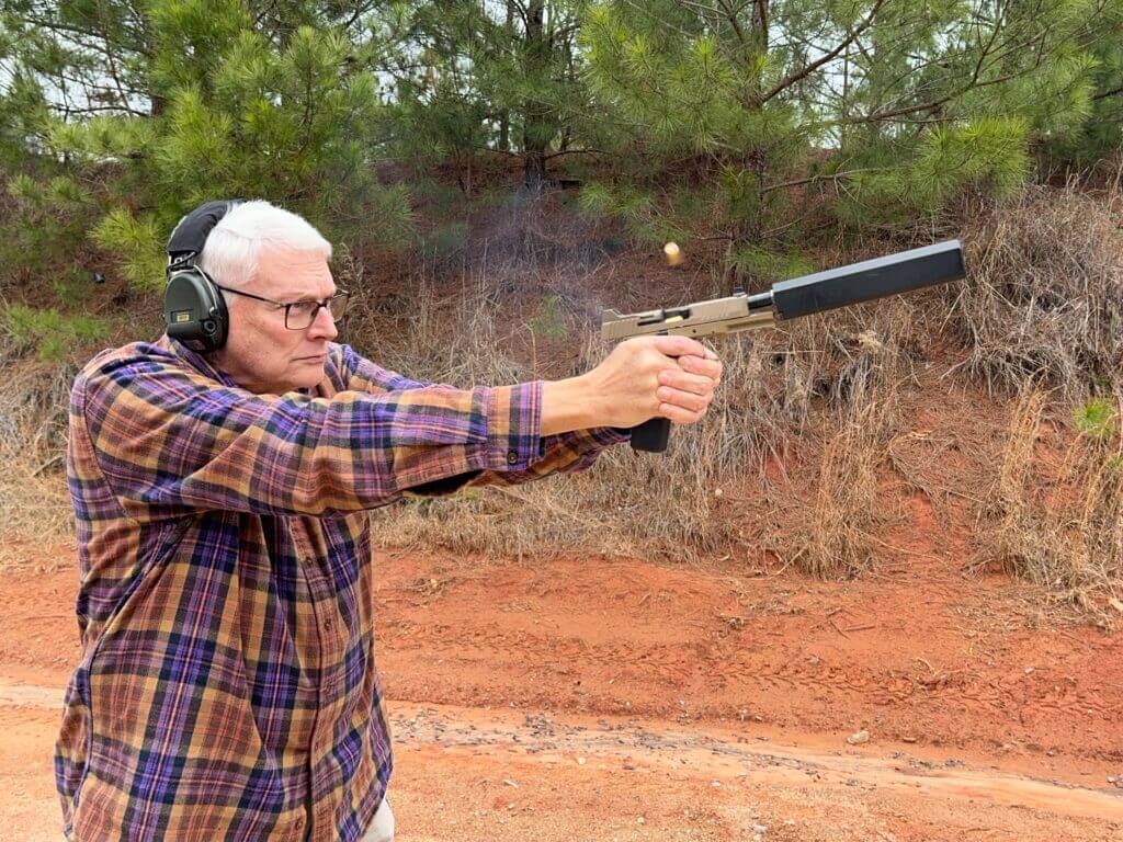 Man shooting suppressed FN 545 Tactical