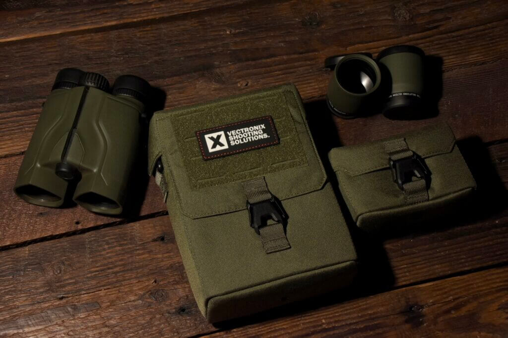 Vector X binoculars and case staged on a wooden background.