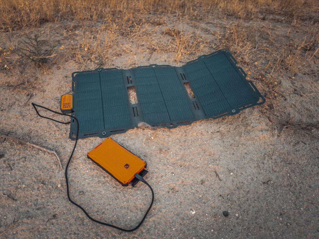 The Dark Energy Spectre plugged in and charging a power bank in the field.