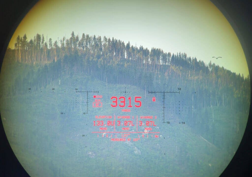 View through the Vector X rangefinder of a distant hill.