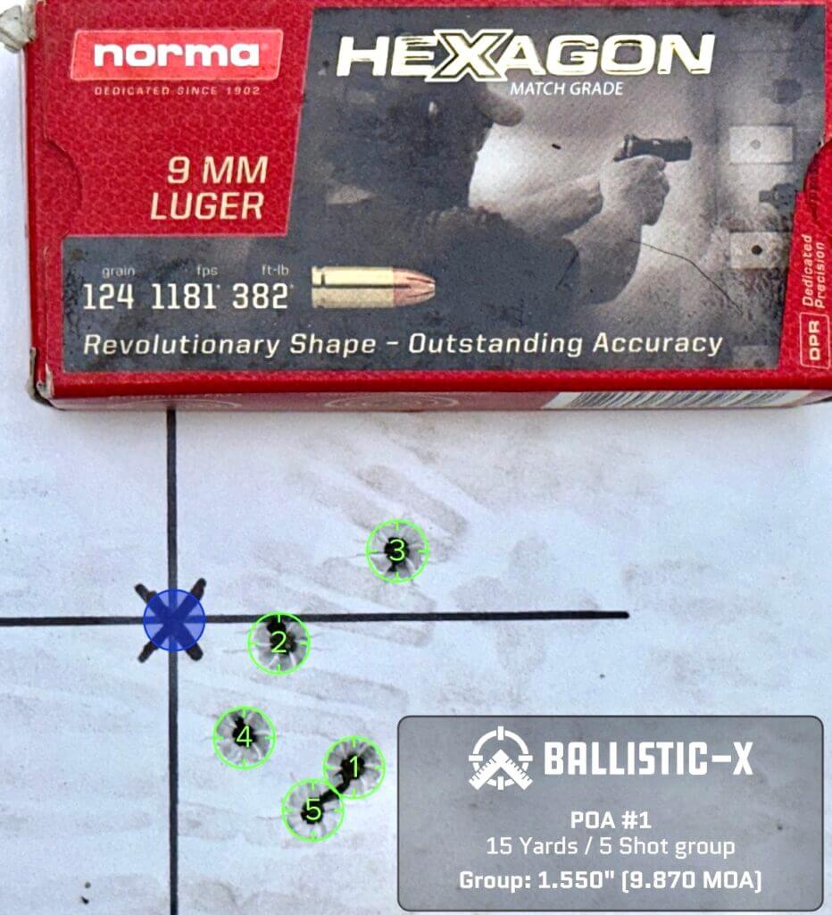 A used pistol target with a box of ammunition on top shows how accurate it is.