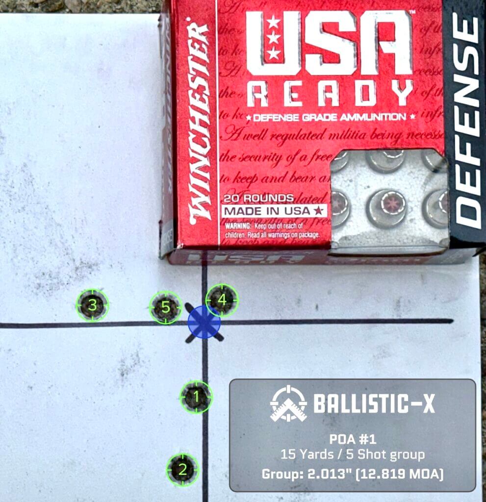 A used pistol target with a box of ammunition on top shows how accurate it is.