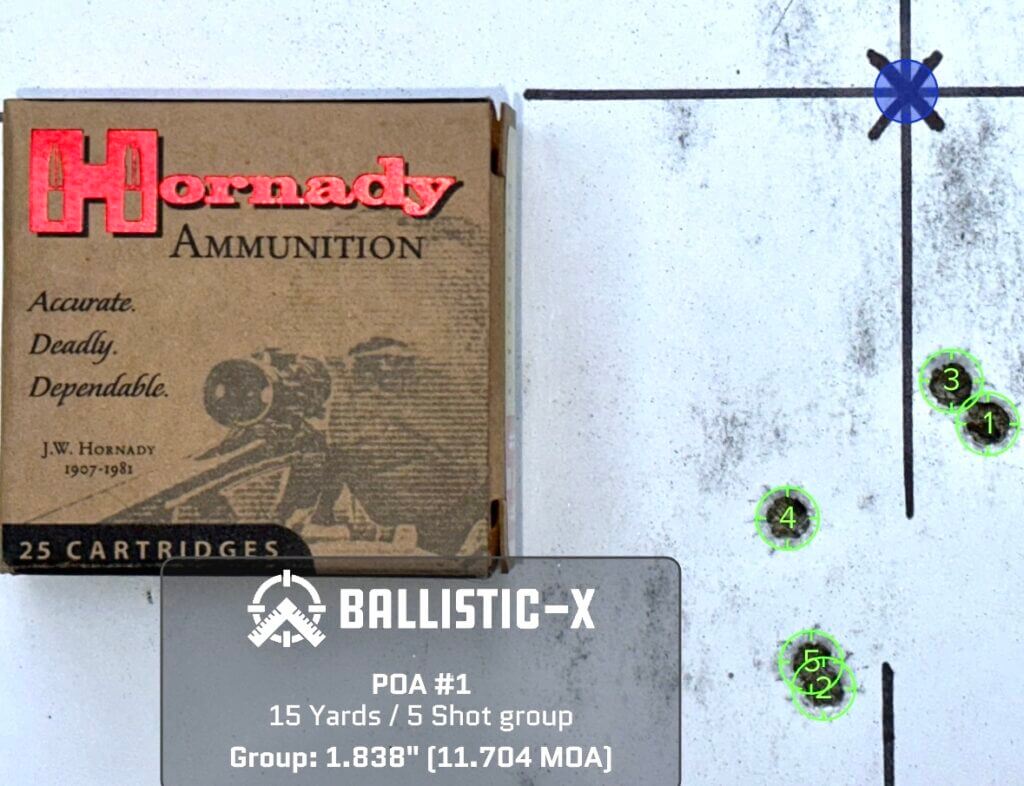 A used pistol target with a box of ammunition on top shows how accurate it is.