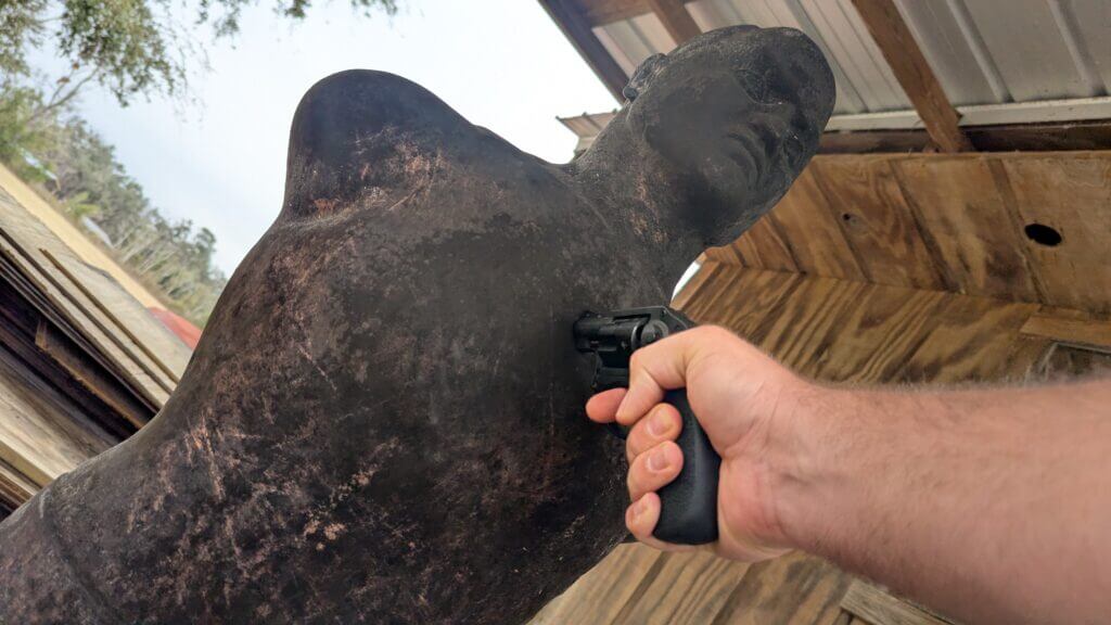 Pressing a revolver muzzle into the target to show out of battery advantage over a semi auto