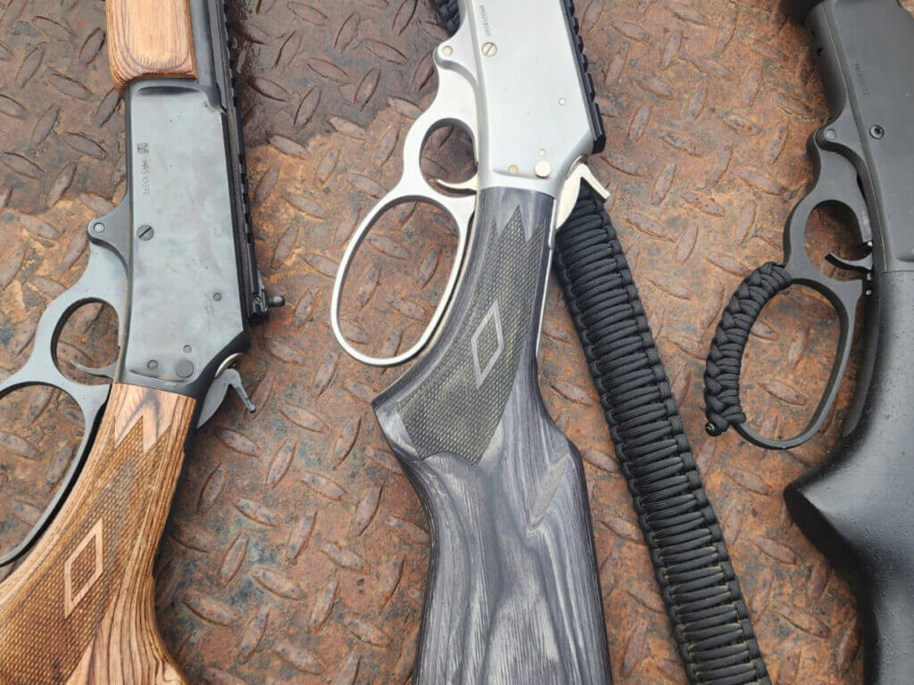 lever-action rifles showing different loop levers and classic hunting setup