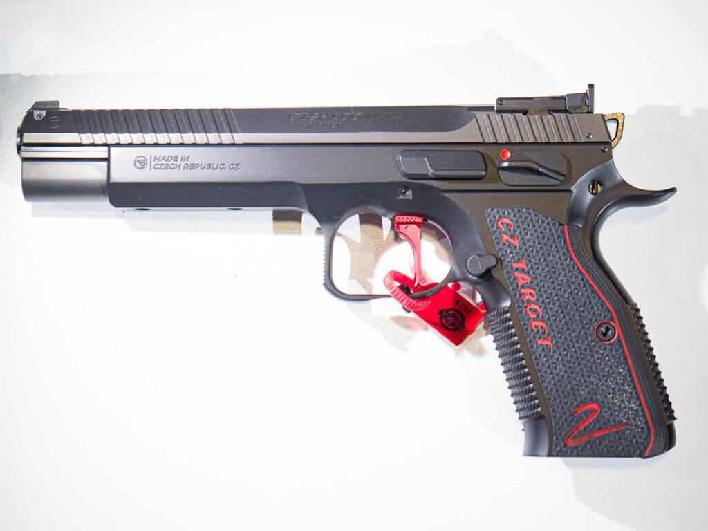 The CZ Shadow 2 Target laying on a white table facing to the left with its left side visible.