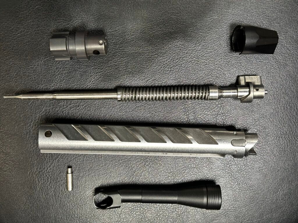 Closeup of a disassembled rifle bolt.
