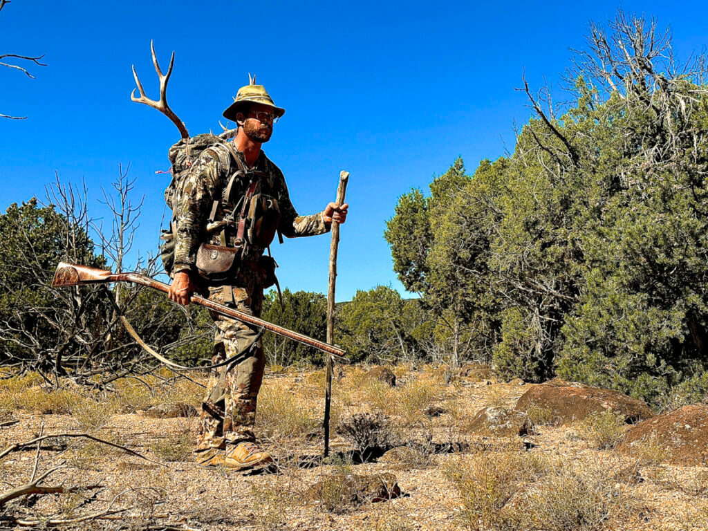 Backcountry pack out after mule deer harvest with traditional flintlock rifle in Utah high desert terrain